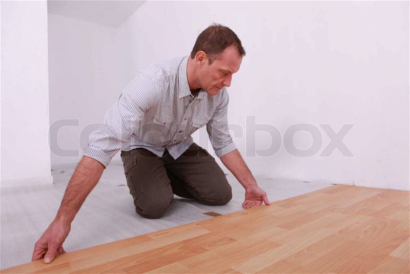 Portrait of a man laying parquet, stock photo