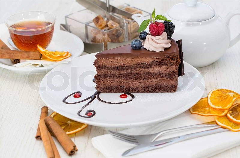 Prague piece of cake decorated with raspberries on a white background, stock photo