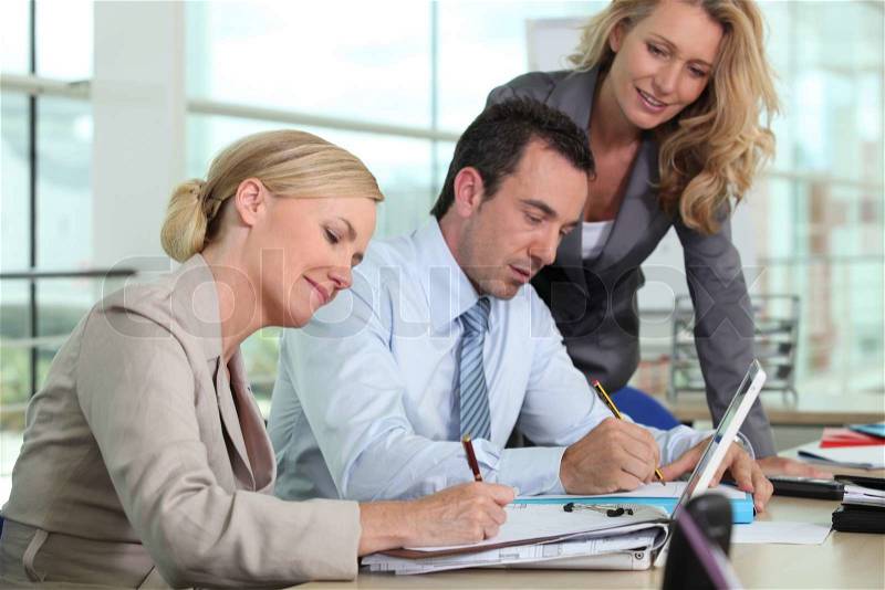 Three colleagues working together, stock photo