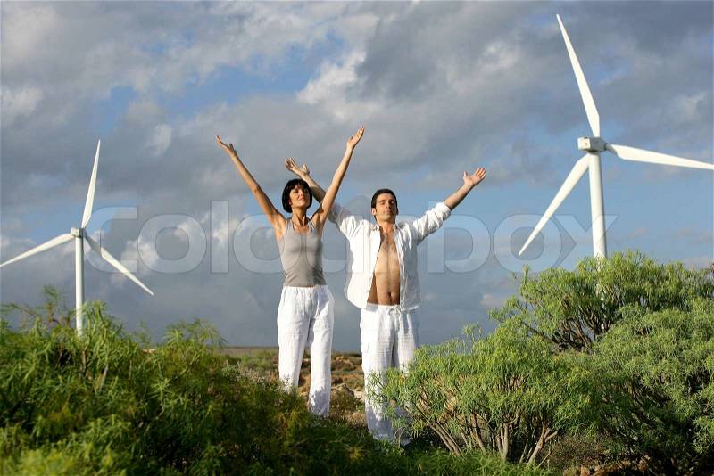 Zen couple on a wind farm, stock photo