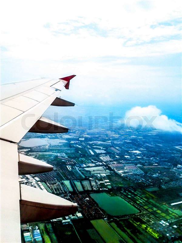 Looking through window aircraft in wing aerial view of landscape and sky vintage, stock photo