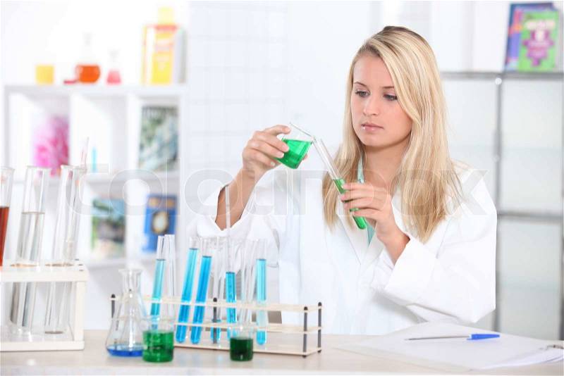 Blond teenager in science laboratory, stock photo