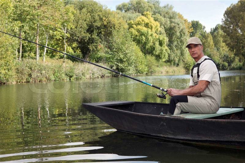 Man fishing on a lake, stock photo