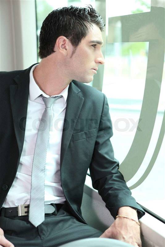 Businessman going to work on tram, stock photo