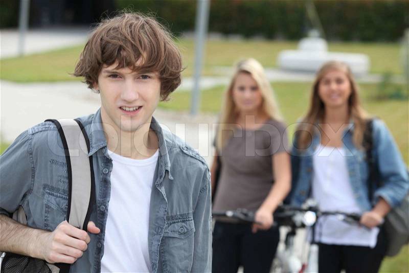 Man standing in front of girls, stock photo