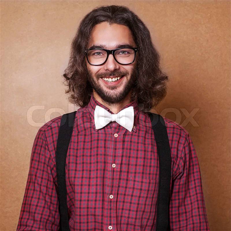 Hipster guy \'s clothes in a cage , suspenders and white butterfly . Close up. Studio shot, stock photo