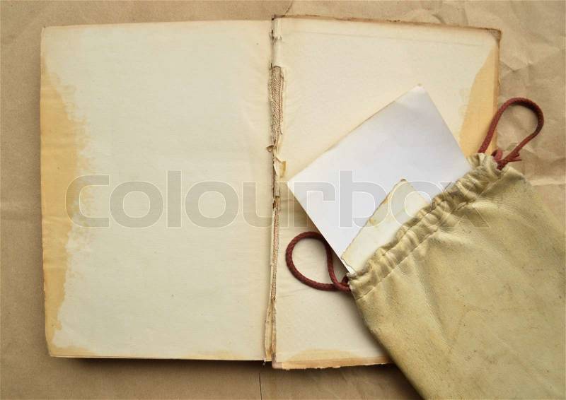 Background with vintage leather bag, with paper and empty open book, stock photo