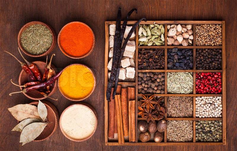 Different types of spices in wooden box, stock photo