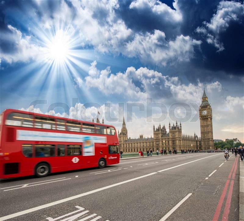 Red Double Decker Bus speeding up to Big Ben Tower on Westminster Bridge, London - UK, stock photo