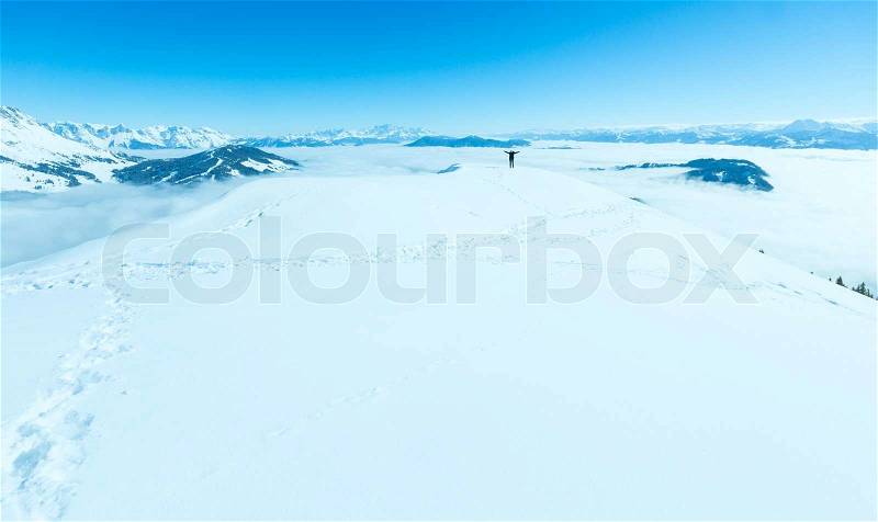 Woman on winter mountain Shneeberg top and view behind Hochkoenig region, Austria, stock photo