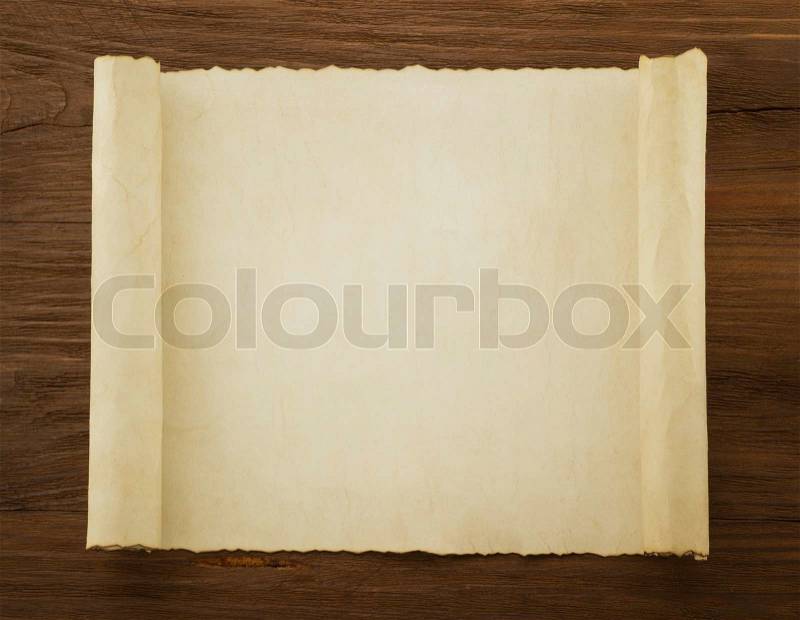 Parchment scroll on wood background, stock photo
