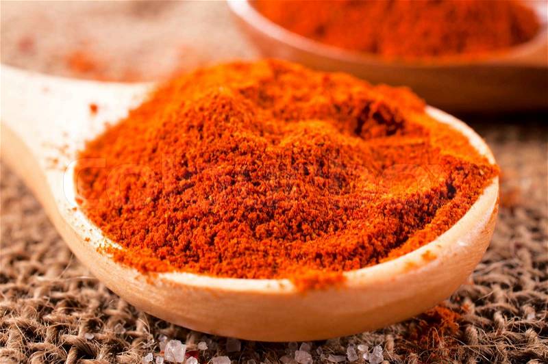 Macro shoot of the red pepper spice in wooden spoon, stock photo