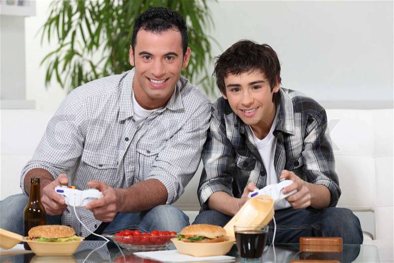 Father and son playing games, stock photo