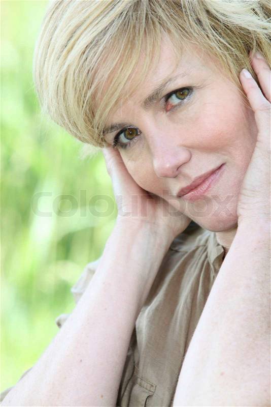 Woman with hands on face, stock photo