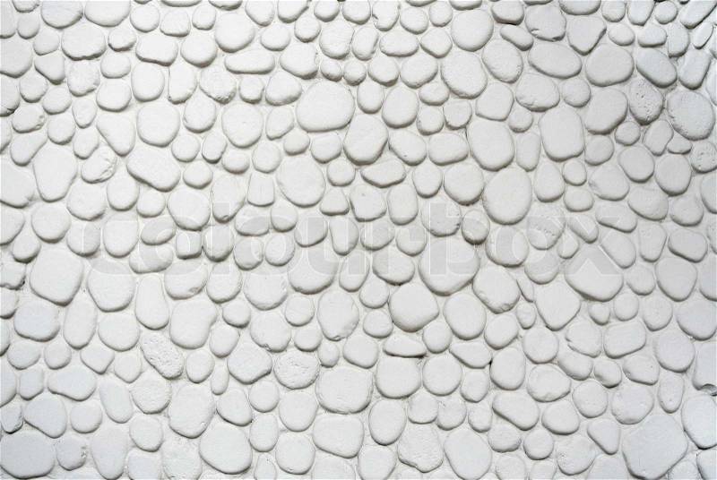 Round stones soft texture white wall background, stock photo