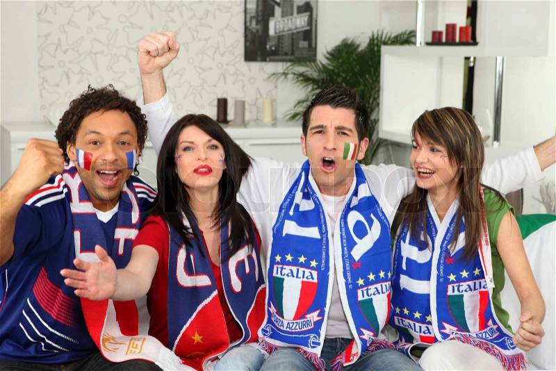 Italian football supporters watching match from home, stock photo