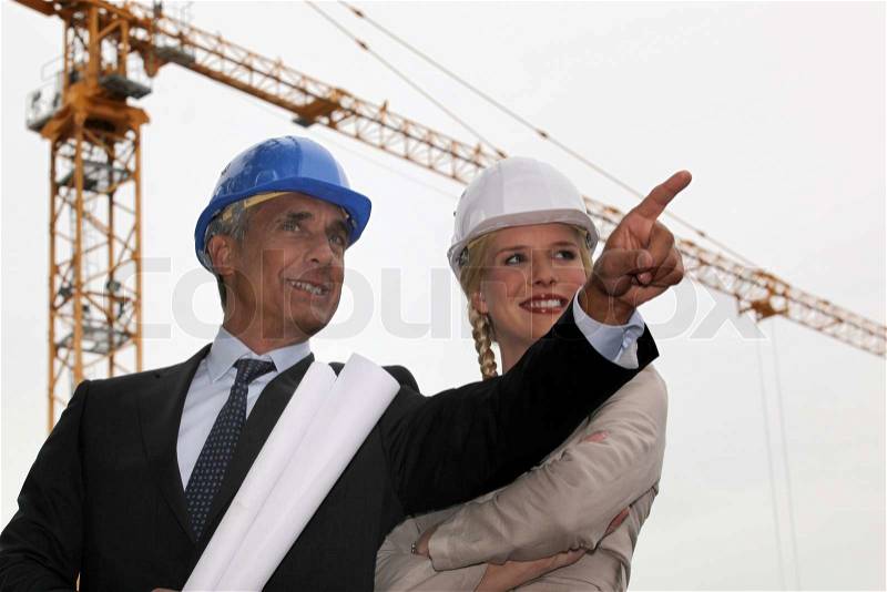 Architect and assistant happy with progress, stock photo