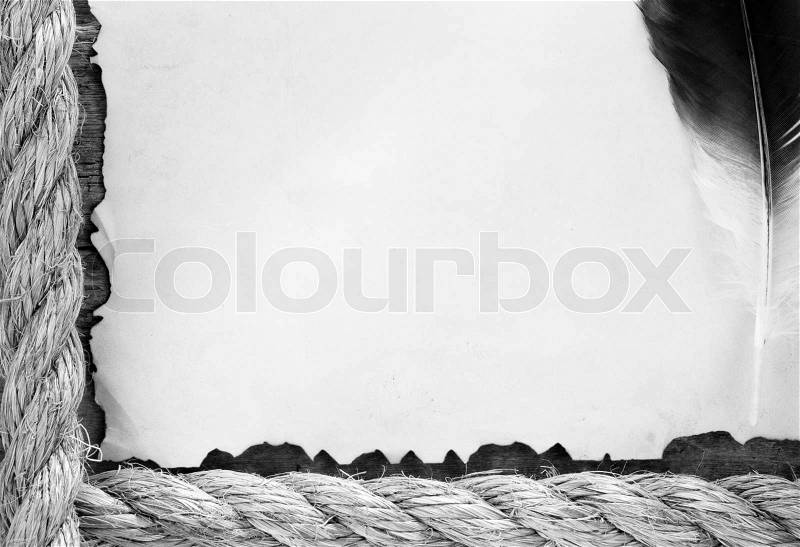 Ship ropes and feather on old vintage ancient paper parchment background, stock photo