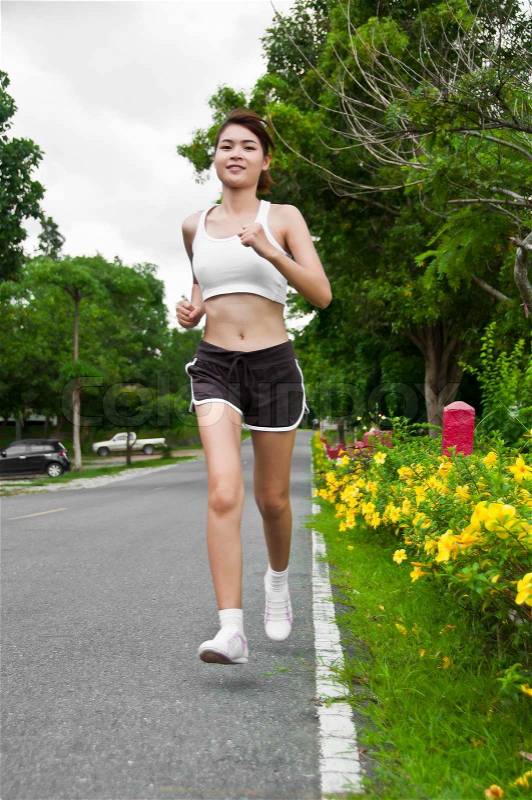 Beautiful Asian woman running, stock photo