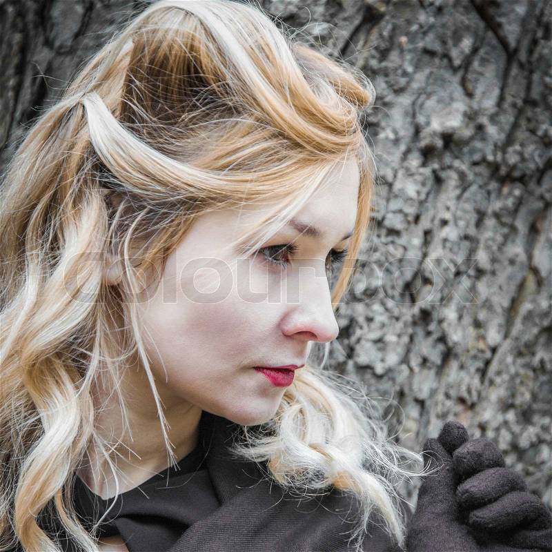 Toned portrait of young woman in profile, stock photo