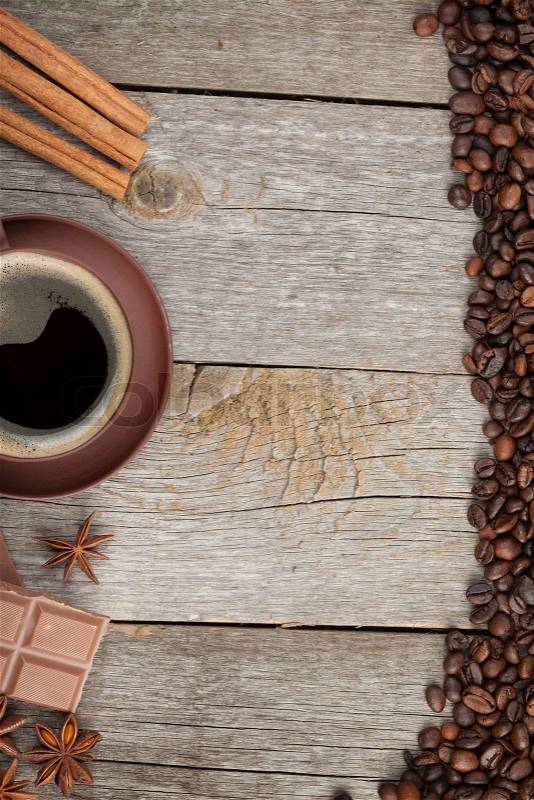 Coffee cup, spices and chocolate on wooden table texture with copy space. View from above, stock photo