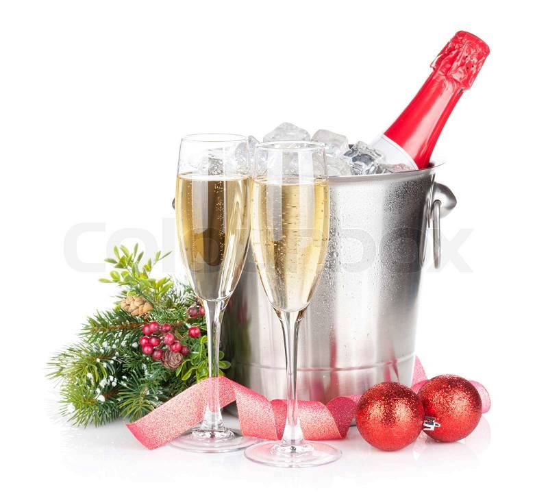Champagne bottle in ice bucket, two glasses and christmas decor. Isolated on white background, stock photo