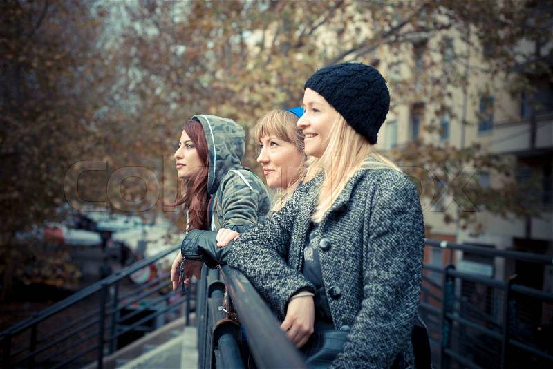 Three friends woman in urban contest, stock photo