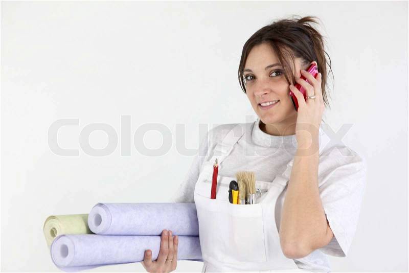 Decorator carrying rolls of wallpaper, stock photo