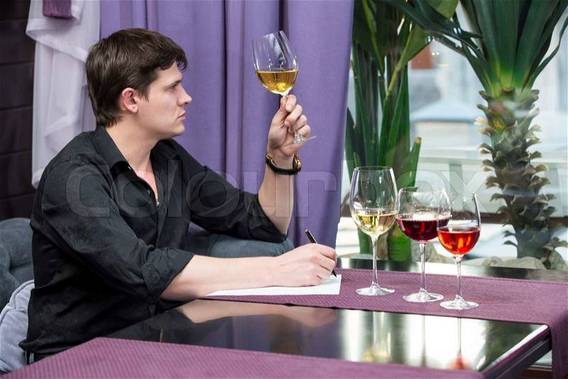 Young man holds wine tasting in the restaurant, stock photo