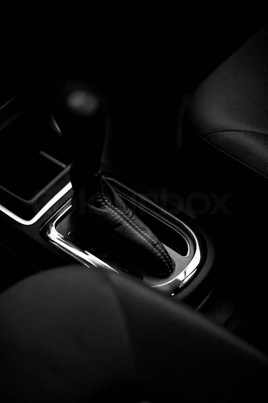 Stick-Shift for Automatic Vehicle Transmission. Black Interior with Seats and Stick-Shift in the Middle. Vehicle Interiors Photo Collection, stock photo