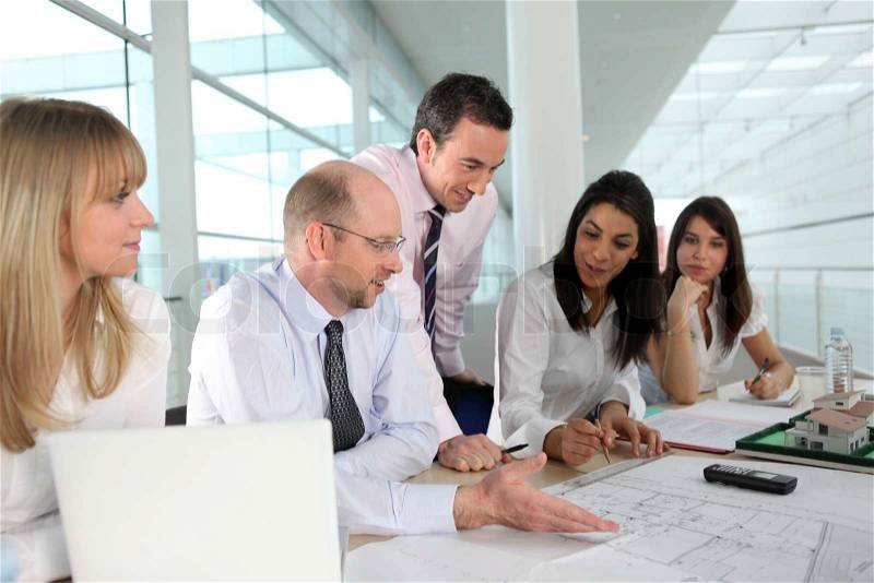 A team of architects discussing a drawing, stock photo