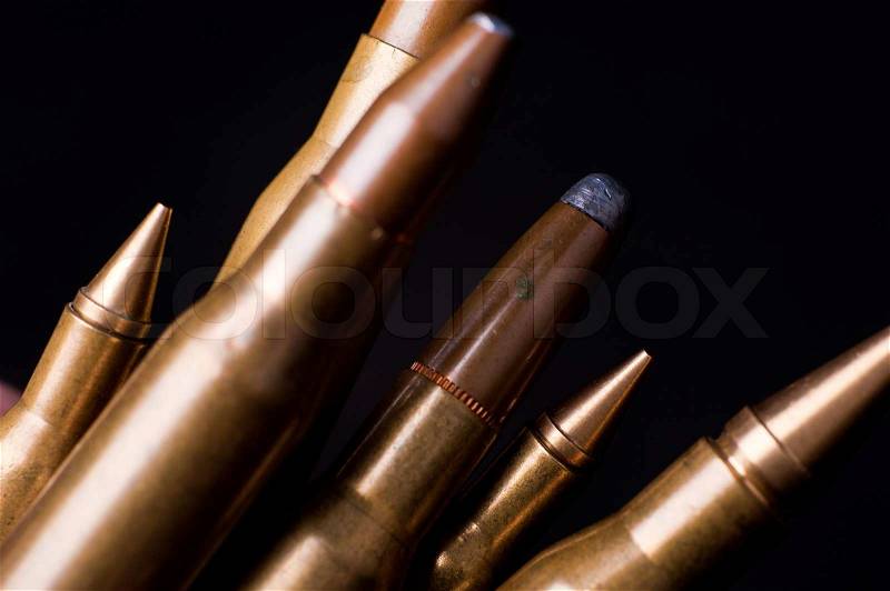 Golden Rifle Bullets on Black Background. Closeup-Macro Photography, stock photo