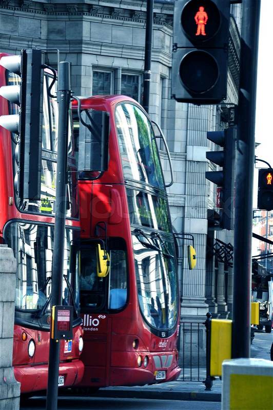 Red London Buses on the Red Street Light. London Public Transportation. Red London Buses Vertical Photography, stock photo