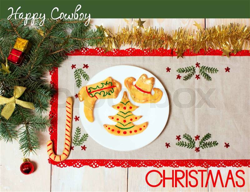 Cowboy Christmas greeting card with cookies on plate.Holiday background with text and holiday decorations, stock photo