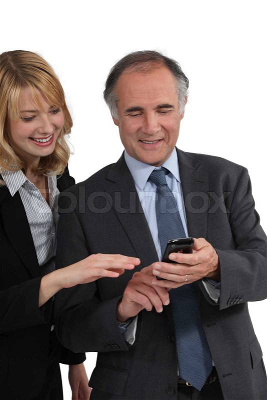 Boss showing a text message to his employee, stock photo