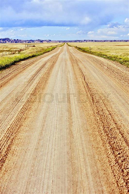 Prairie Gravel Road in South Dakota, U.S.A. Vertical Photography. Straight Country Gravel Road to the Badlands. , stock photo