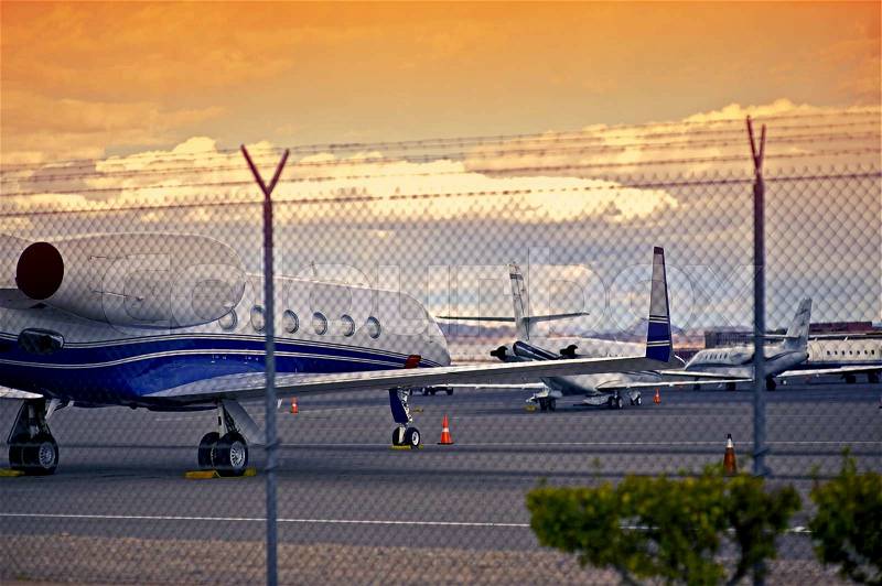 Airport with Small Jet Planes. Air Transportation Theme. Airport Fence, stock photo