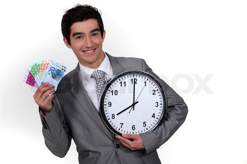 Young businessman with a wad of cash by 8 o\'clock, stock photo