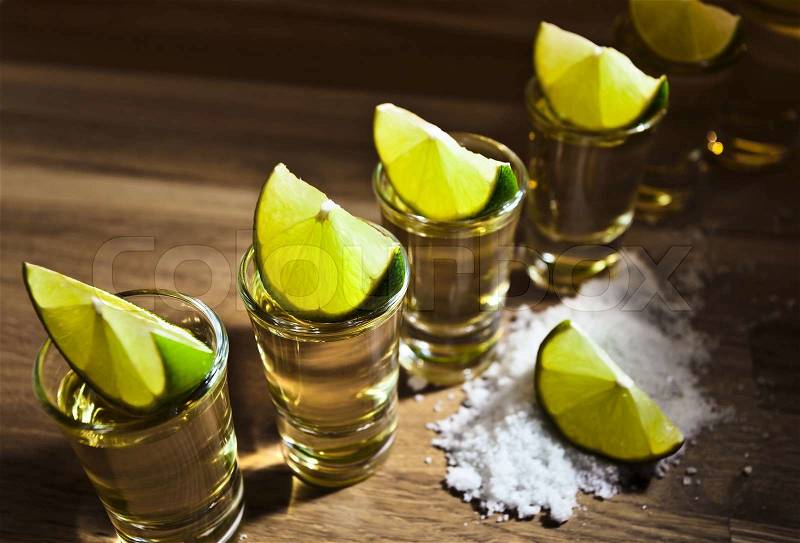 Tequila , lime and salt on wooden table, stock photo