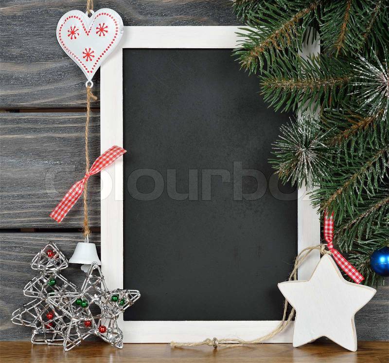 Writing board and Christmas decorations on a gray background, stock photo
