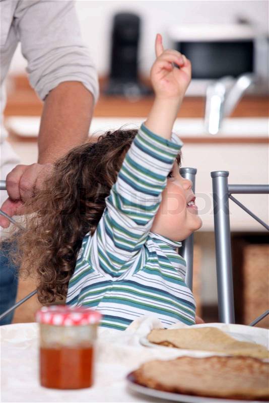 Toddler raising arm to ask for permission, stock photo