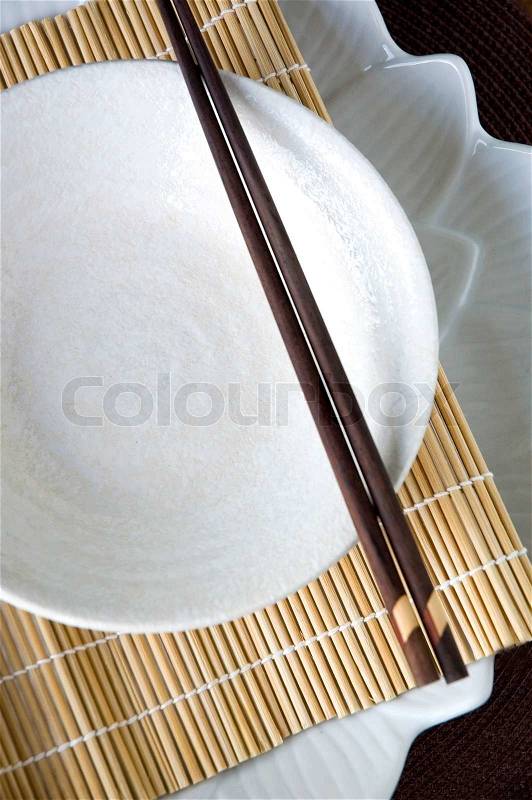 White dish on bamboo mat, stock photo
