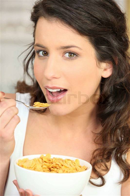 Young woman eating cereal, stock photo