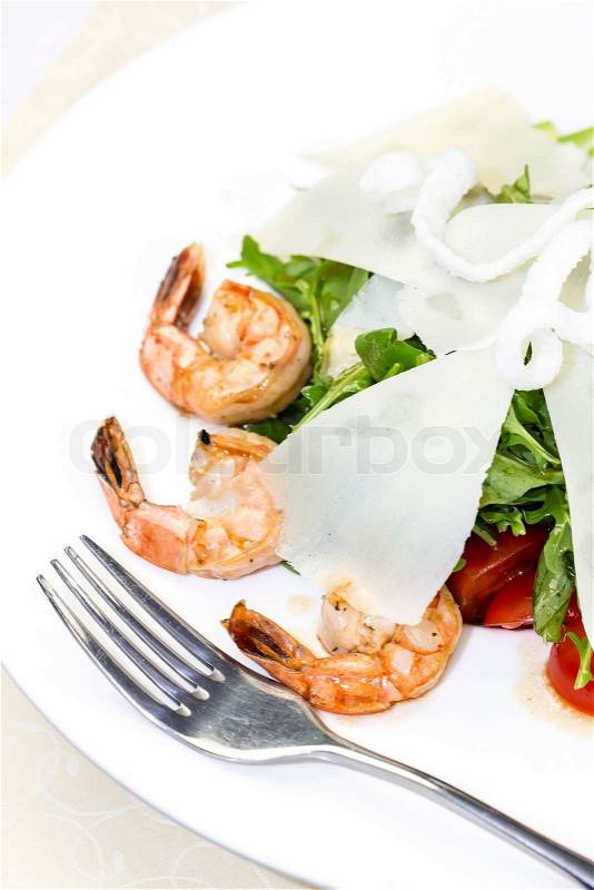 Shrimp salad and greens on a white background, stock photo