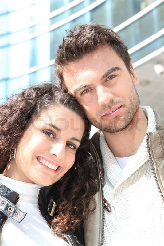 Couple outside high-rise building, stock photo