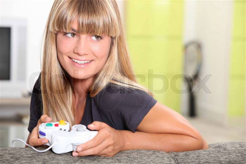 Blonde woman playing video games, stock photo