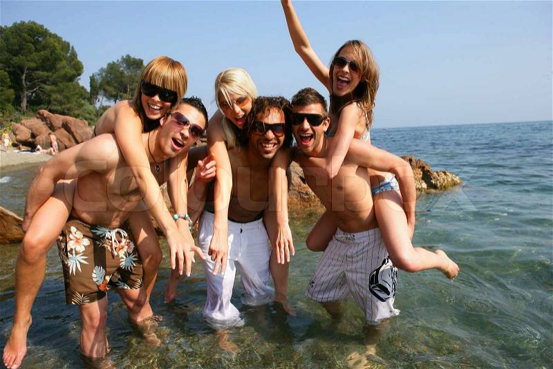 Young people having fun at beach, stock photo