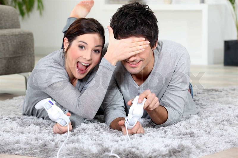 Playful couple with video games, stock photo