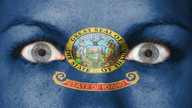 Close up of eyes. Painted face with flag of Idaho, stock photo