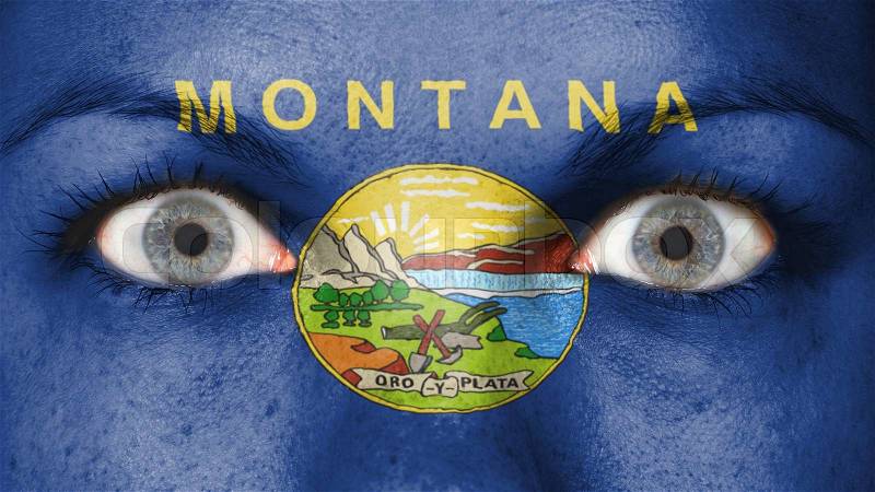 Close up of eyes. Painted face with flag of Montana, stock photo